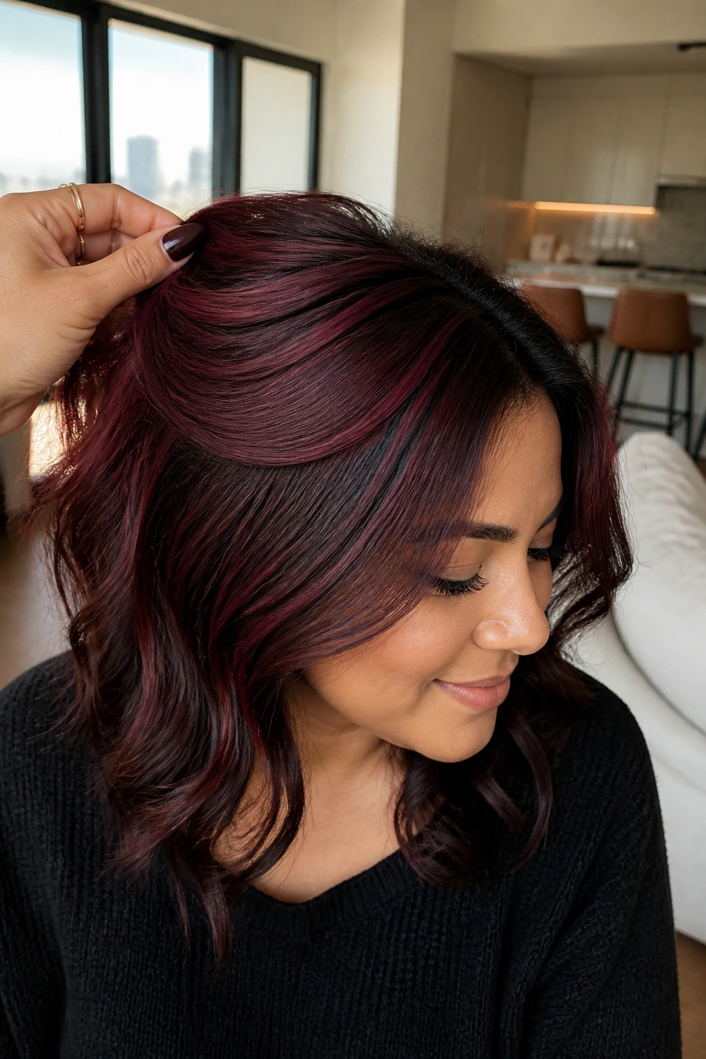 Close-up showing mulled wine balayage around crown on hair.