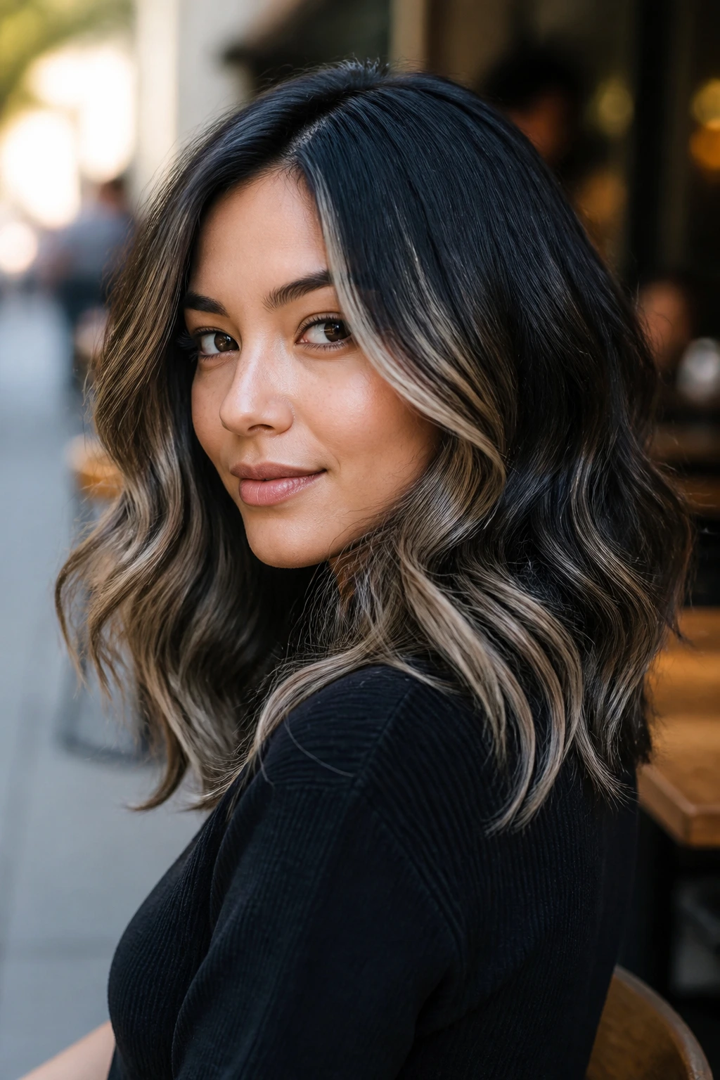 Close-up of wavy black hair with mushroom blonde ribbons