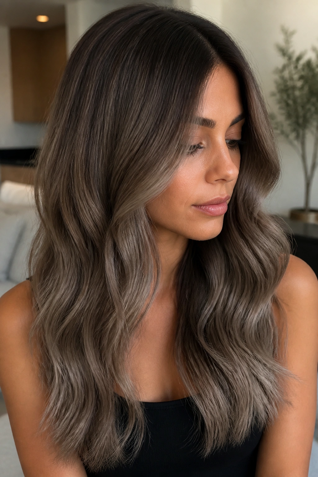 Real woman with mushroom brown ash ombre in long hair.