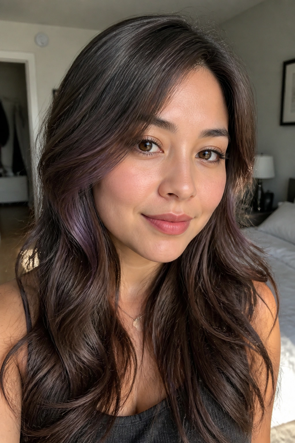 Close-up portrait of a real woman with mushroom brown hair and a subtle purple sheen near the cheeks