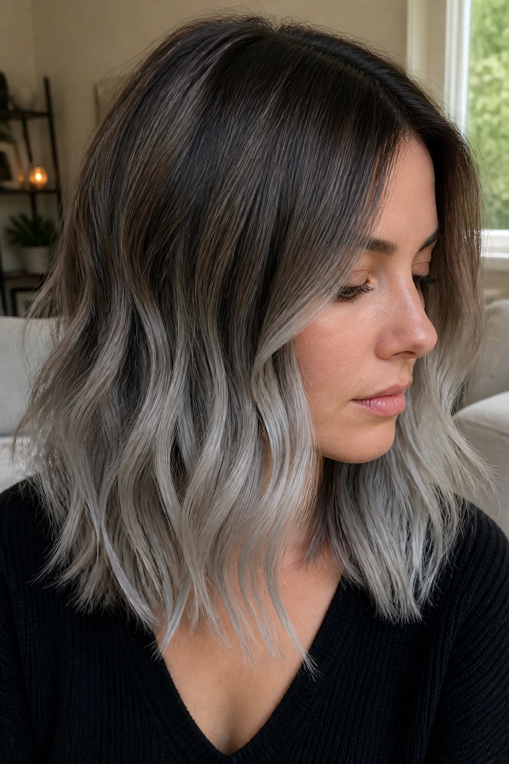 Close-up of a real woman showing mushroom brown roots transitioning to silver ends