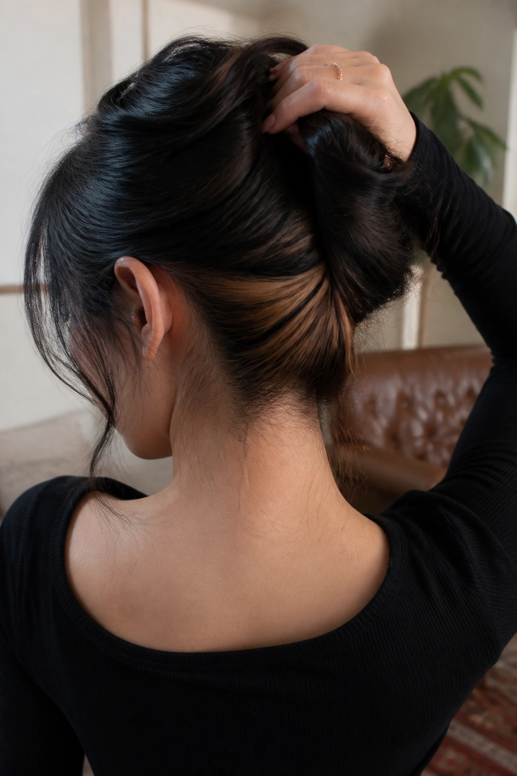 Close-up of real person's nape with caramel peek-through in dark hair