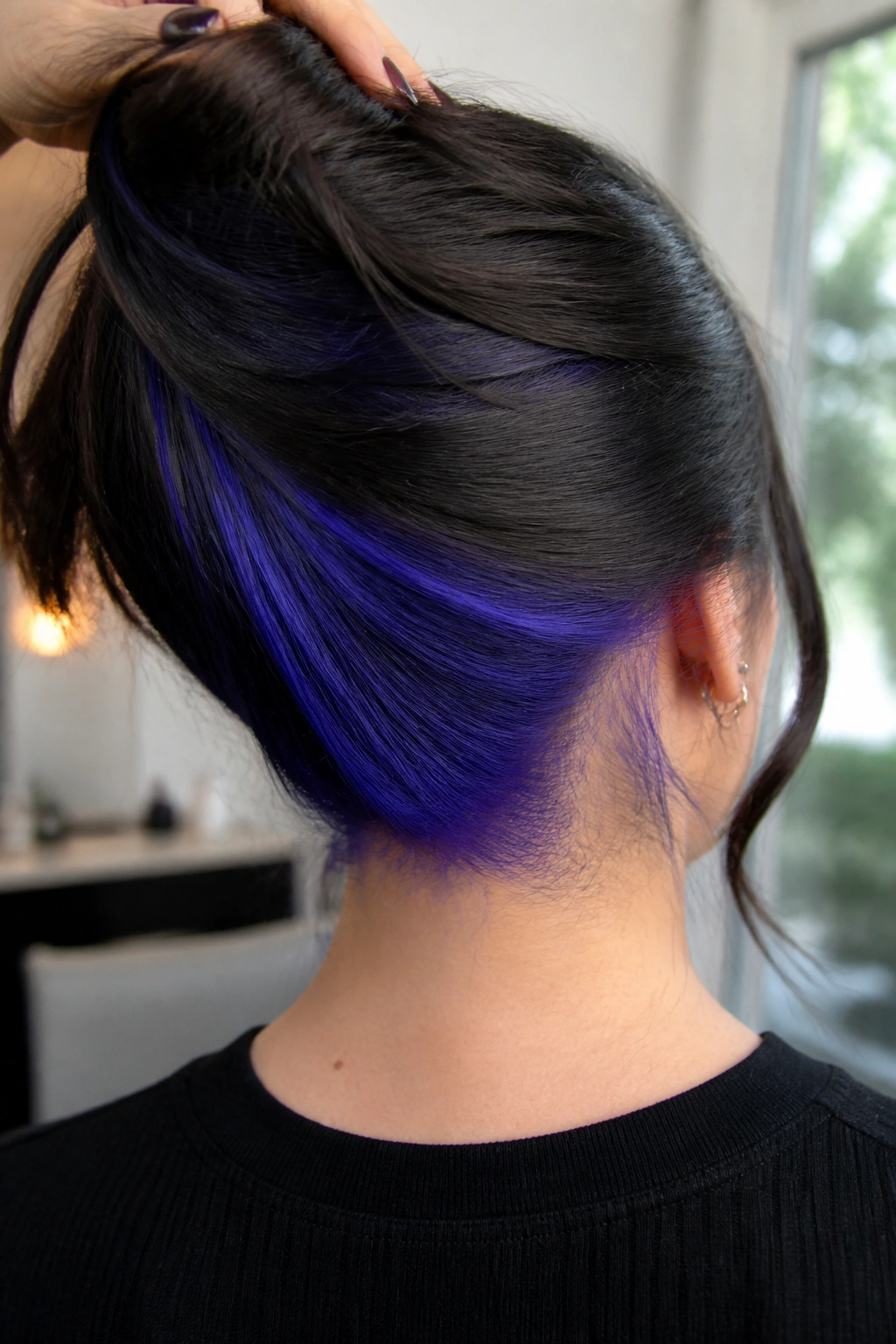 Back of head with blue-violet underlights at the nape on a real person