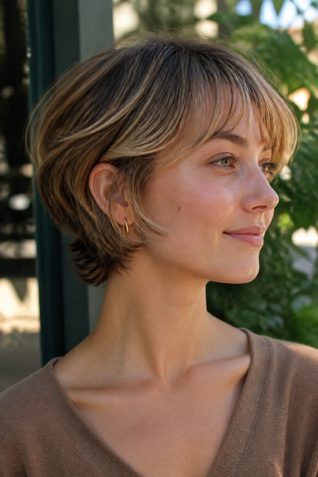 Close-up of a real woman with neck-length bixie showing back nape and front length.