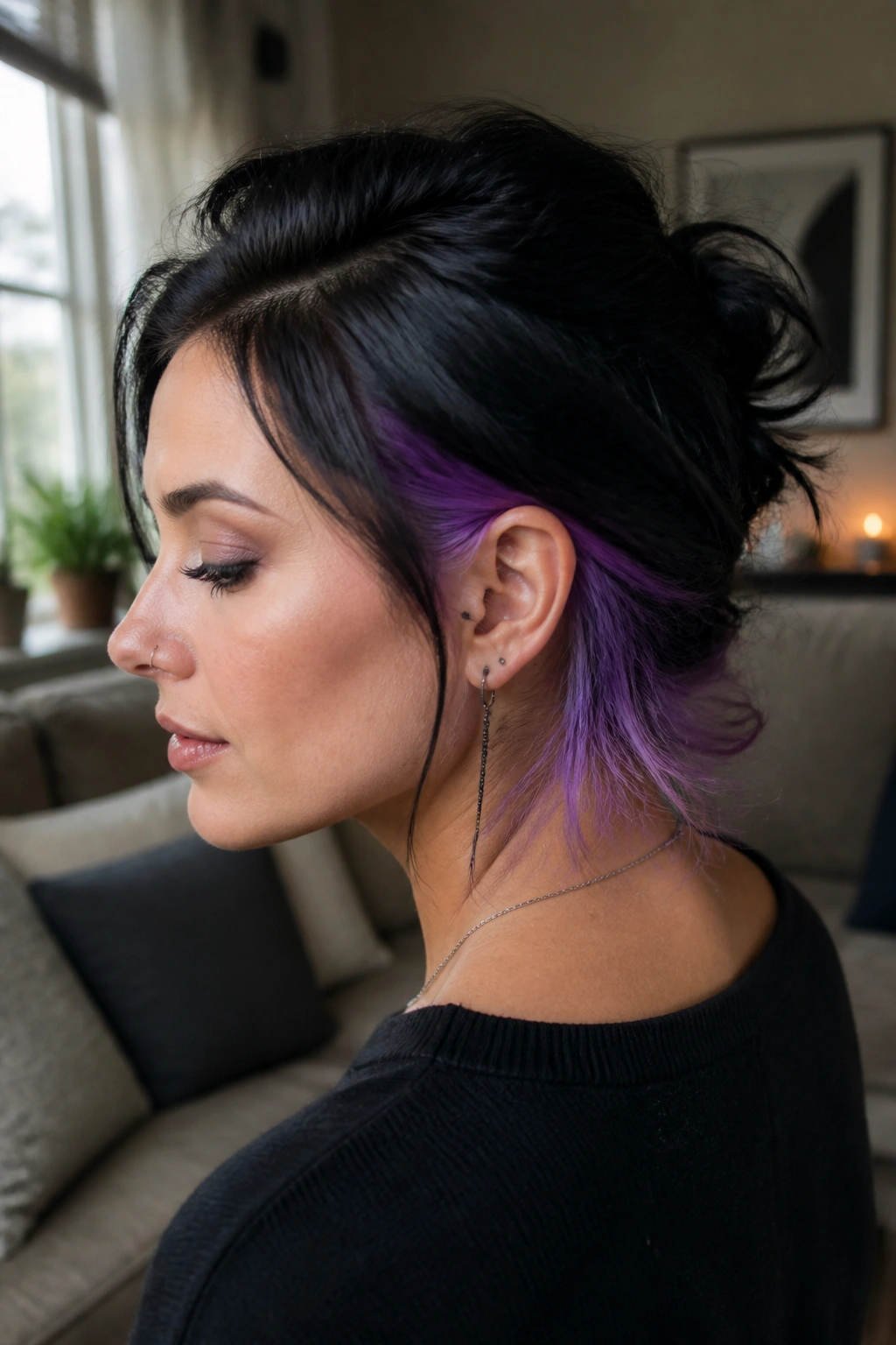 Close-up portrait of a real person showing neon violet peekaboo underlayer at the nape.