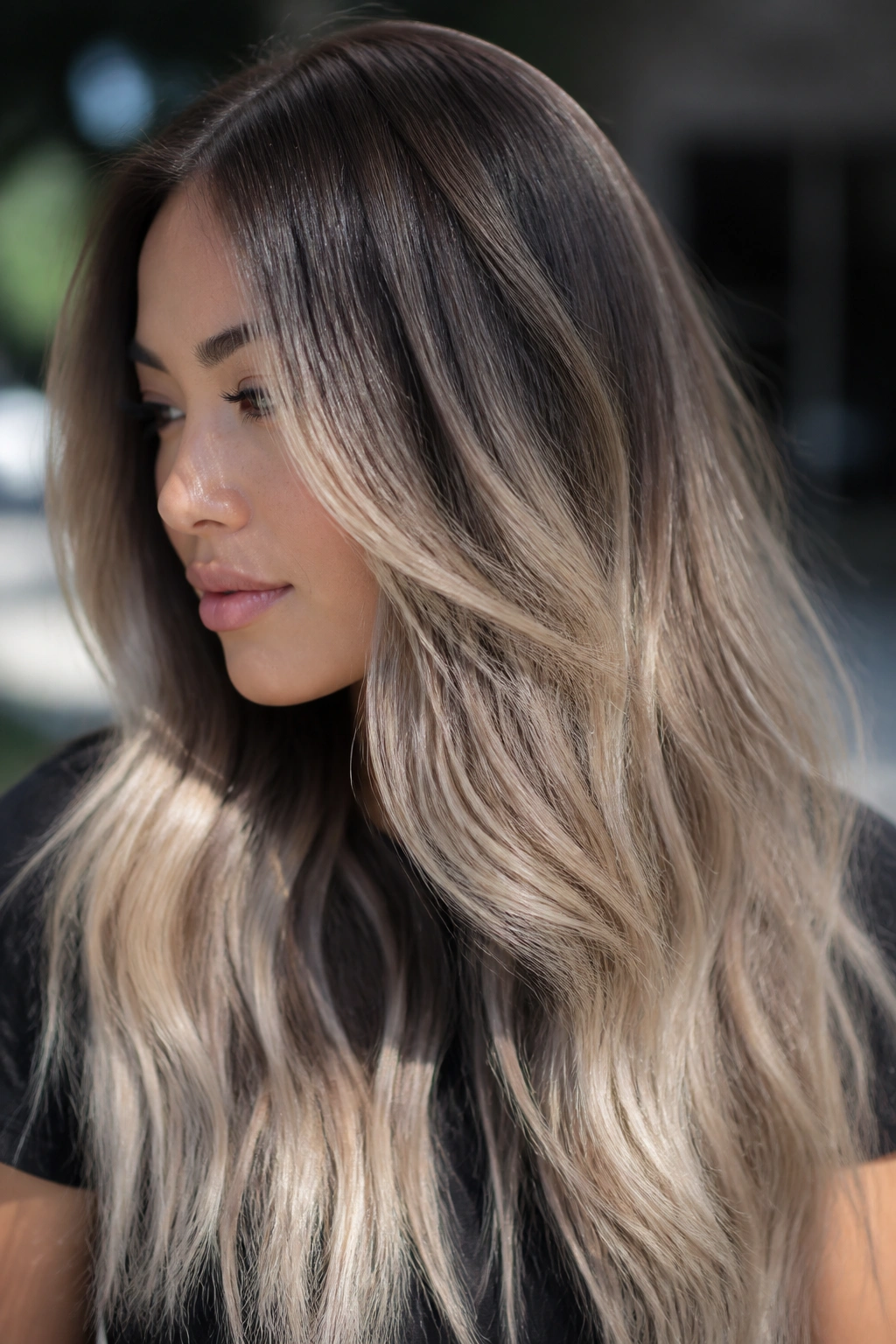Close-up portrait of a real woman with ombre-balayage ash blonde on long hair