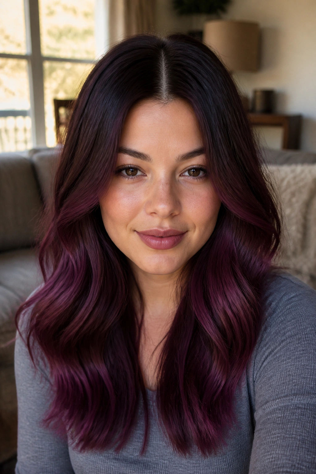 Center-parted merlot-purple ombré hair on a real person