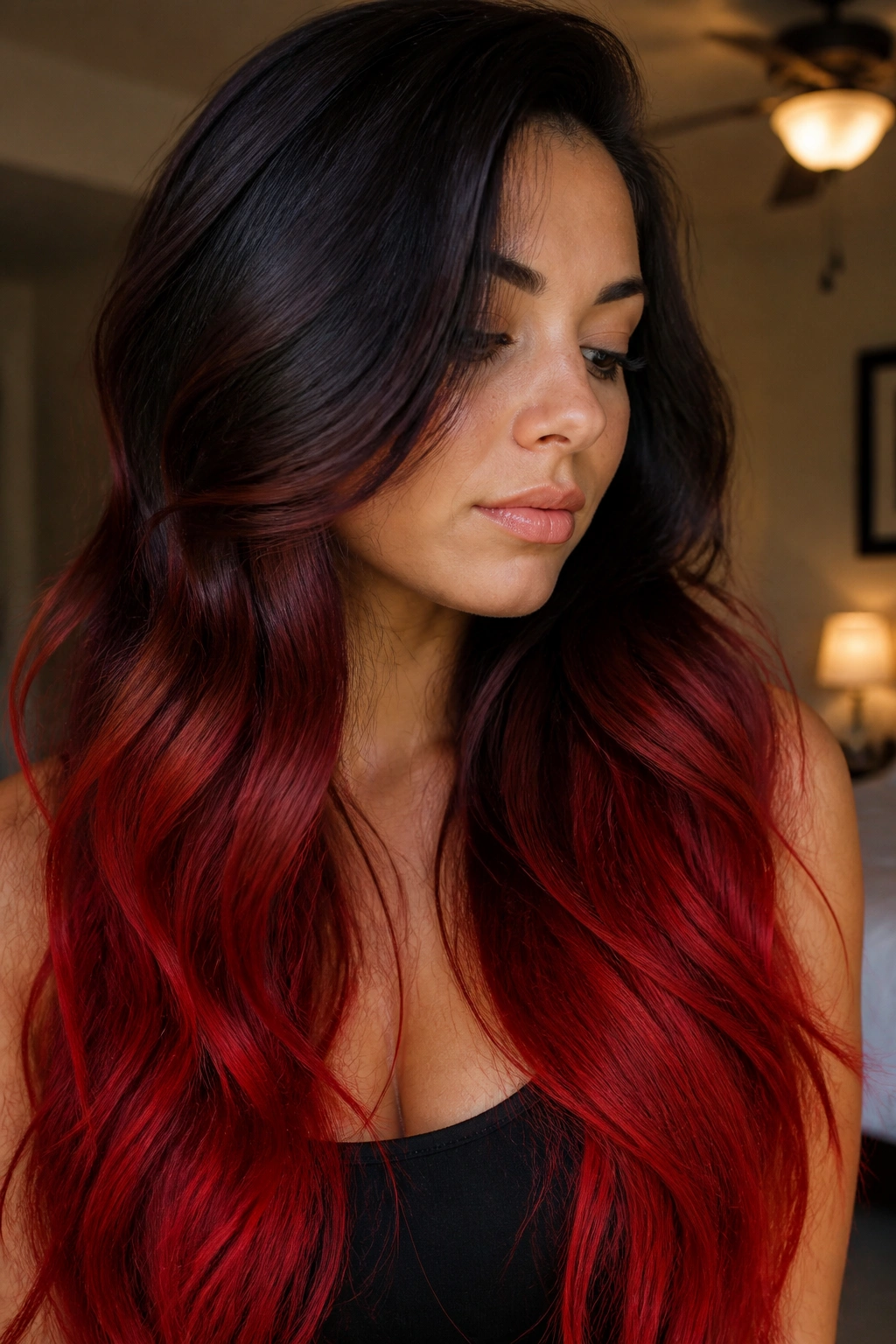 Close-up portrait of a real person with hair gradient from near-black brown to chili pepper red.