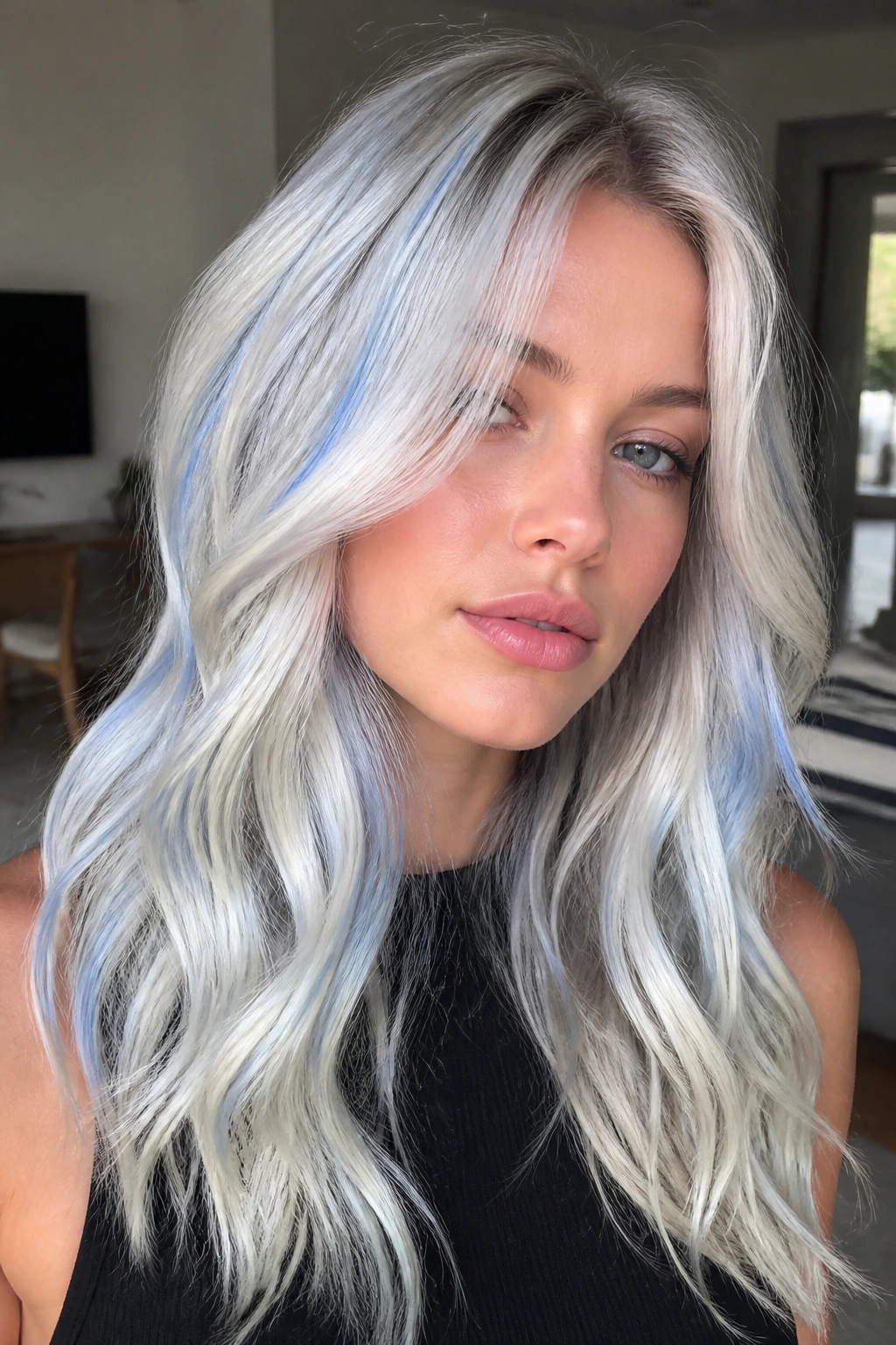 Close-up of a real person with opal blonde hair and blue reflections catching light