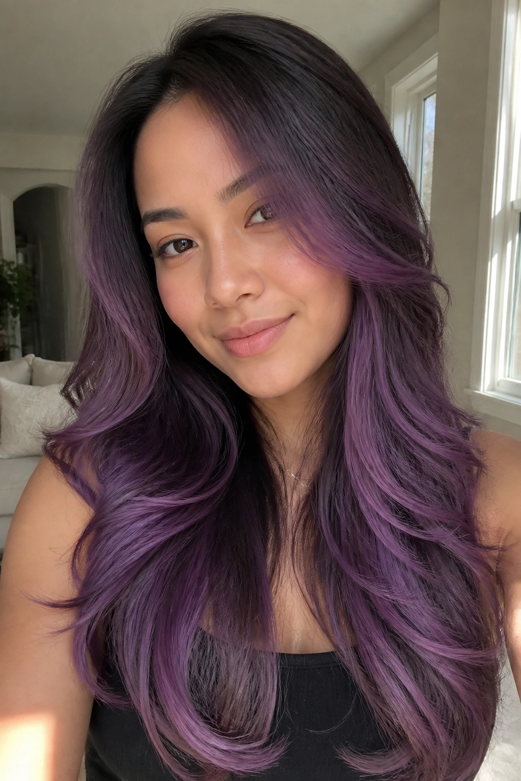 Portrait of woman with orchid balayage on long layers
