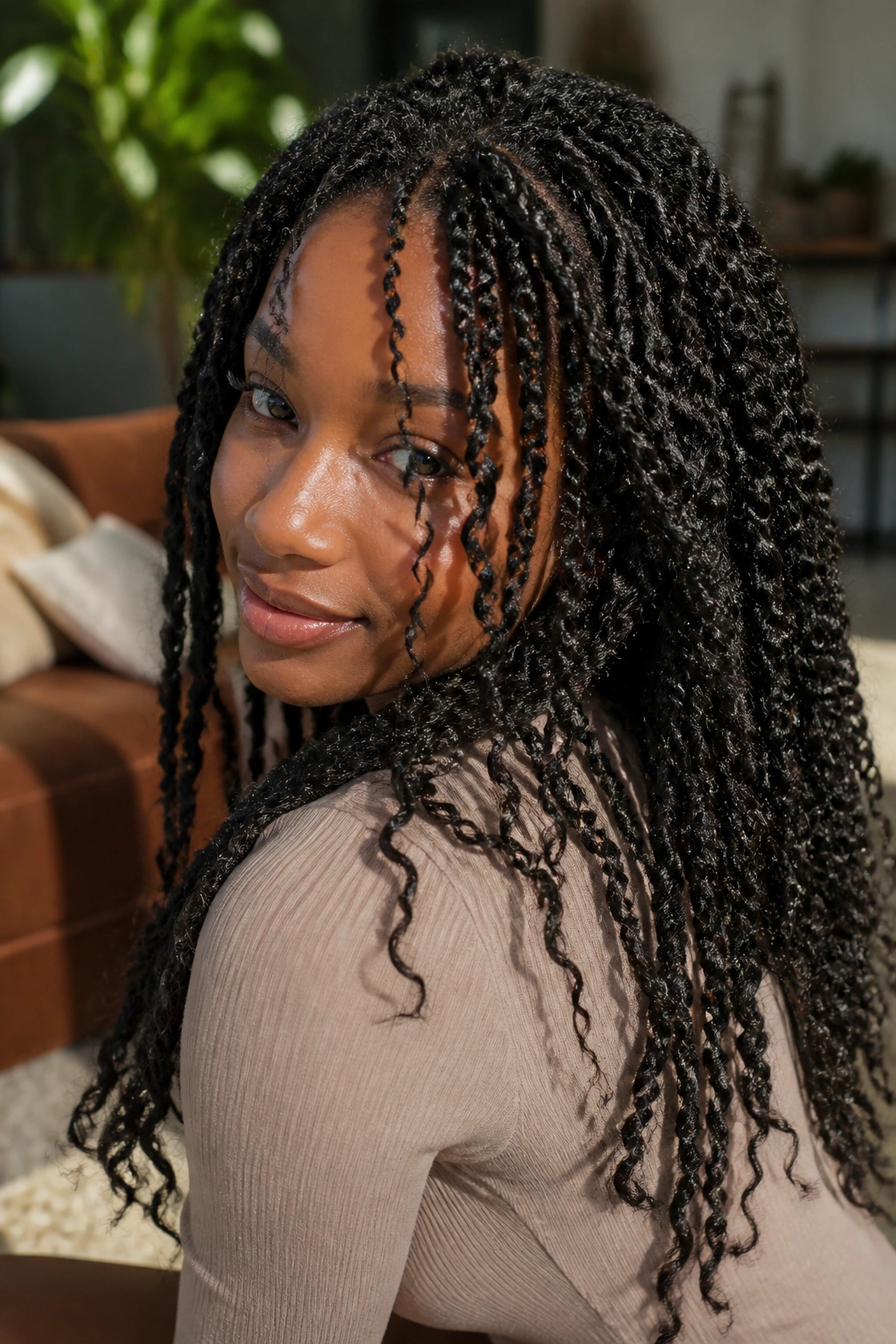 Real person wearing passion twists in warm living room light