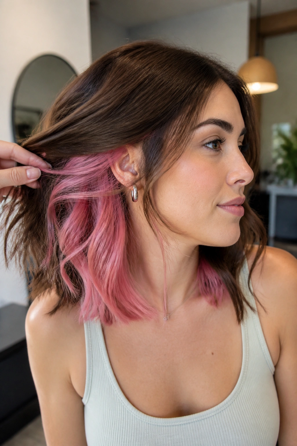 Portrait showing pastel pink peekaboo panels under brown hair at the nape