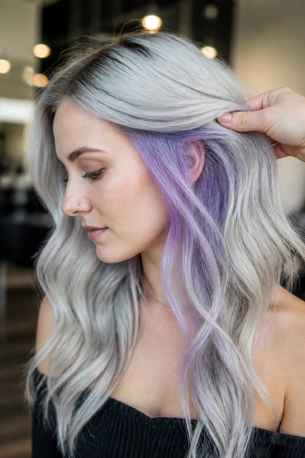 Close-up of a woman with pastel purple underlights under icy silver top layer