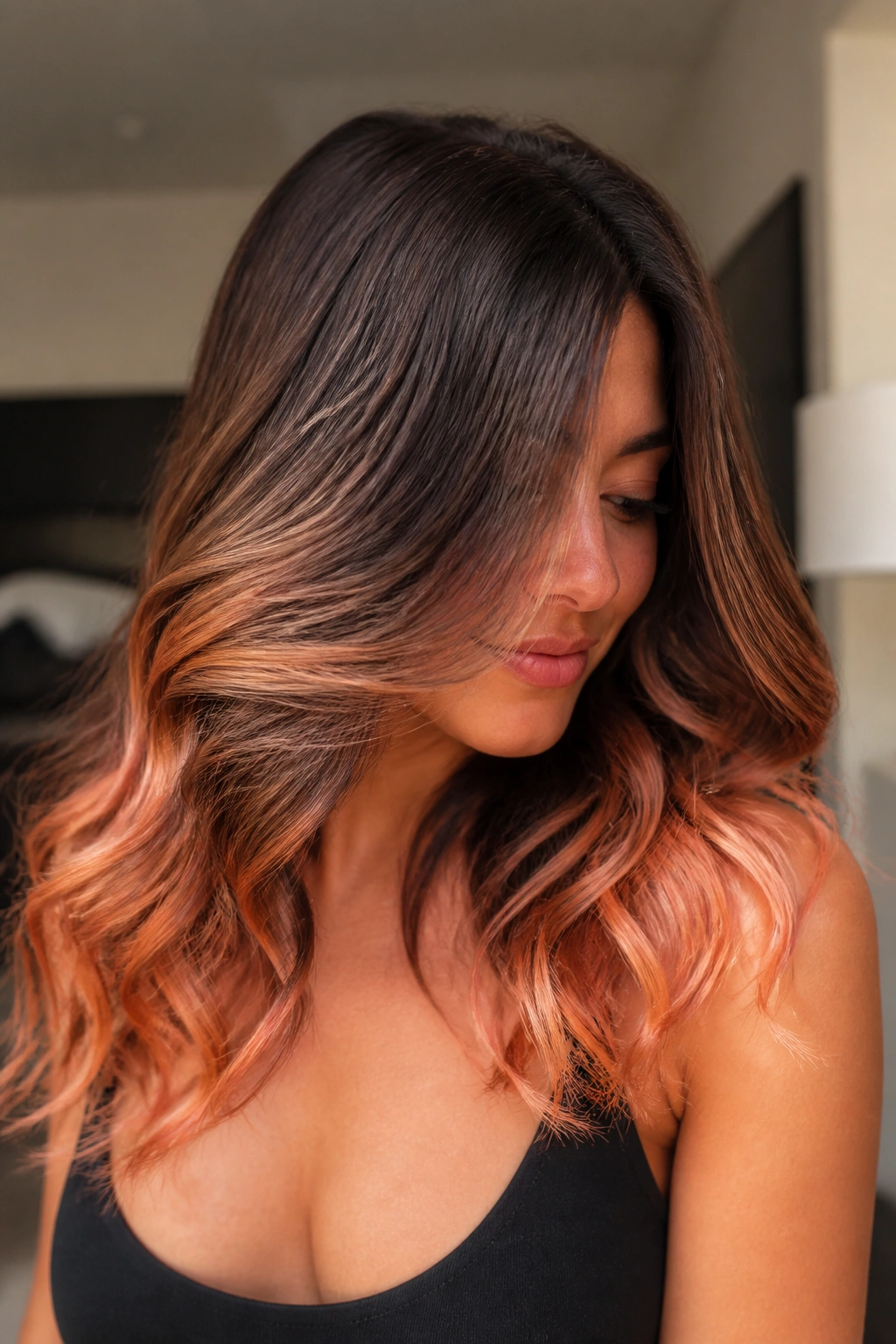 Close-up of a real woman showing peachy ginger ends on brown hair