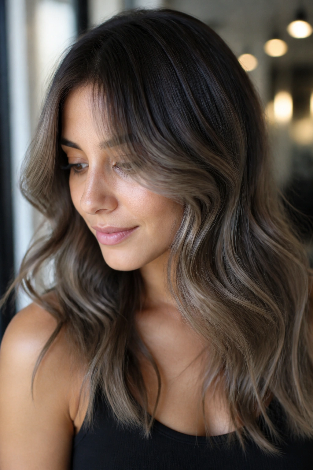 Close-up portrait of a real person with pearl balayage on a warm brunette base