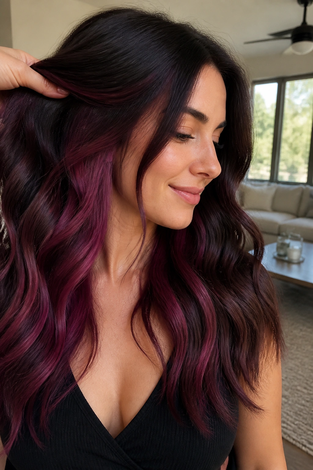 Brunette hair with blackberry pink peekaboo underlayers visible during movement
