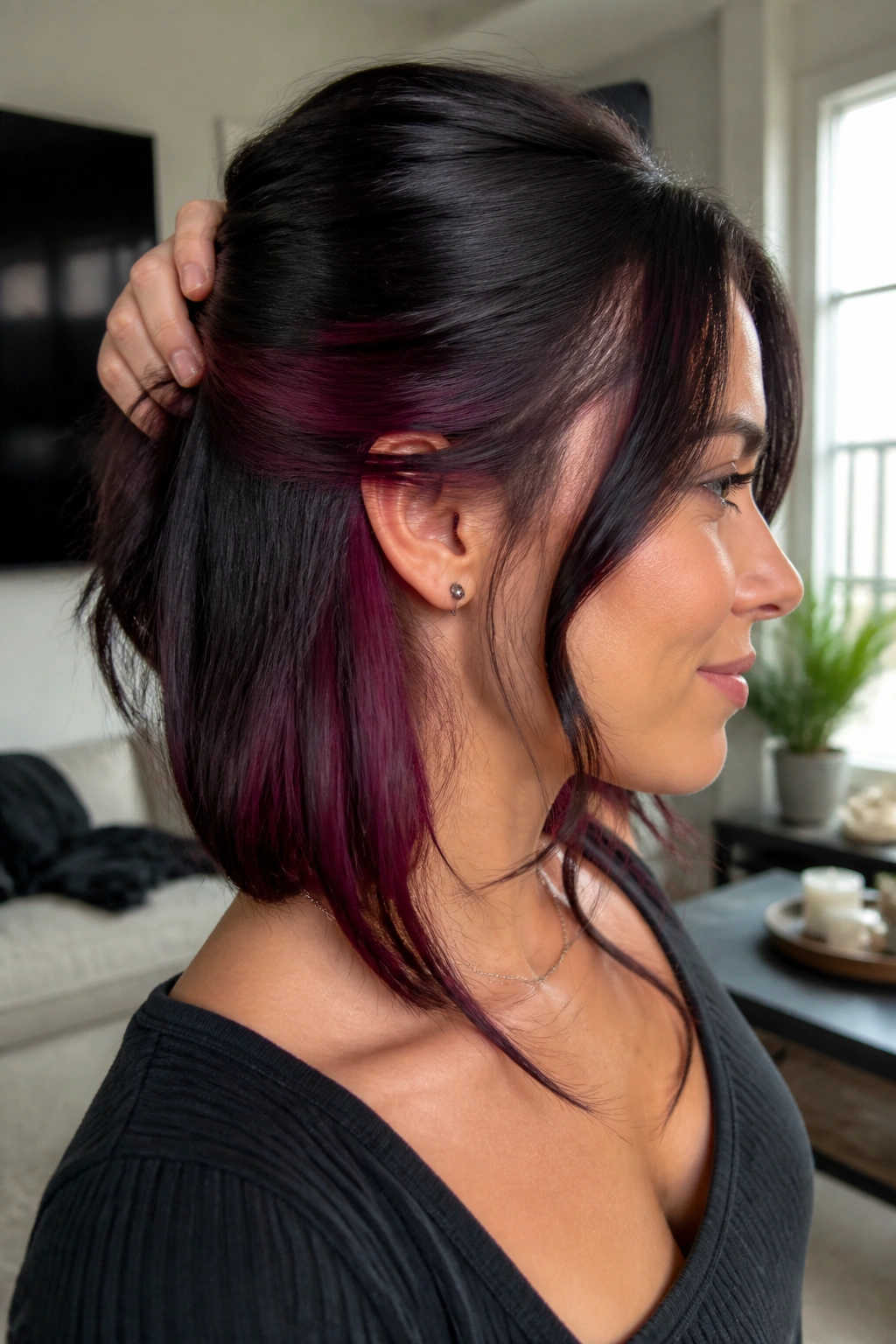 Close-up of hair revealing blackberry peekaboo panels under the top layer