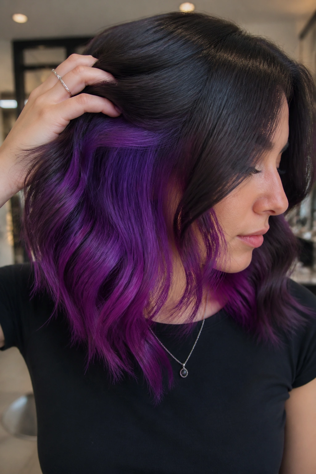 Portrait of a person with hidden purple peekaboo panels under a darker top layer