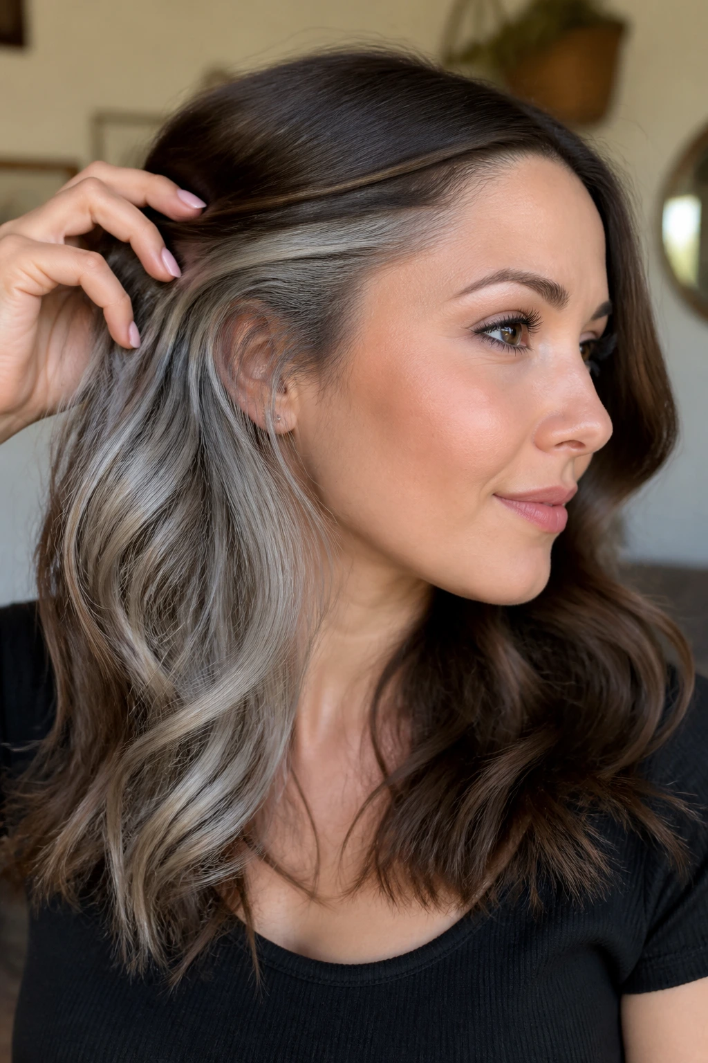Close-up of a real woman showing hidden silver panels under brown hair behind the ear.