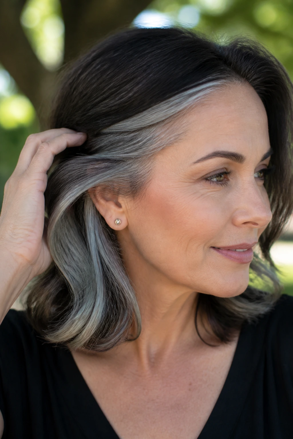 Real woman with hidden peekaboo silver highlights under top layers