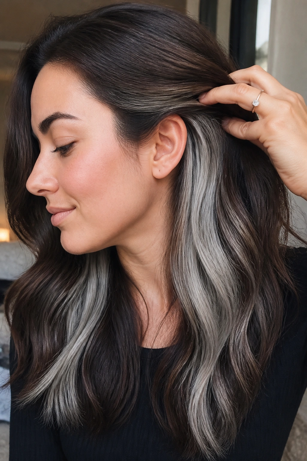 Close-up of hidden silver panels underneath brown hair revealed by movement