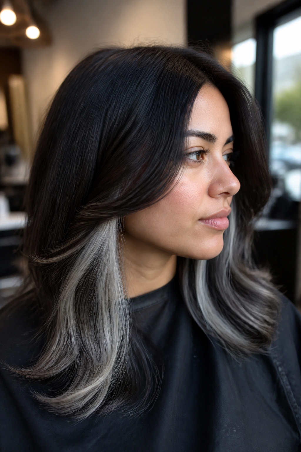 Close-up of dark hair with hidden silver panels peeking from beneath the top layer