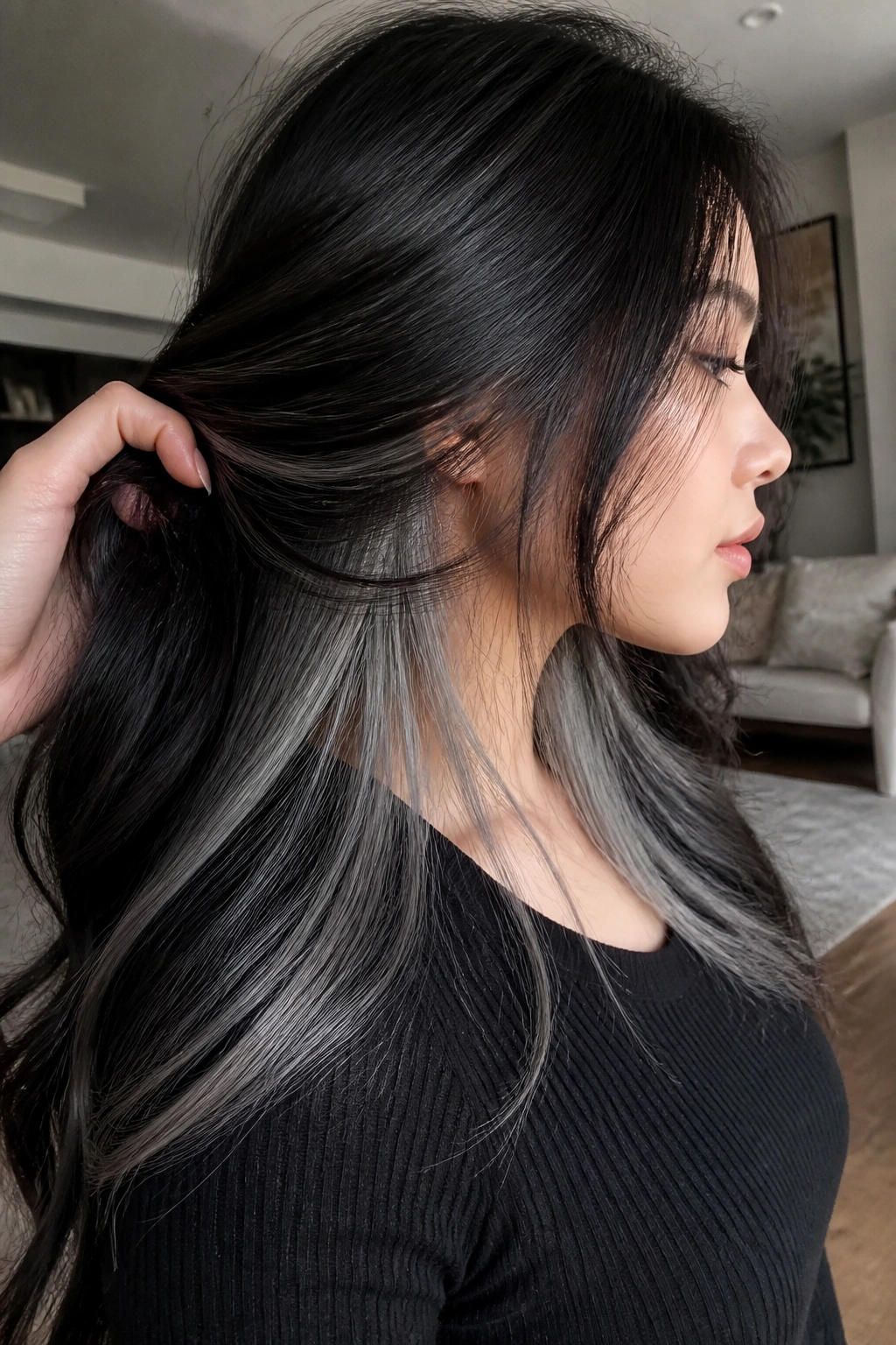 Portrait of a real woman with hidden silver underlayers peeking from beneath dark hair.