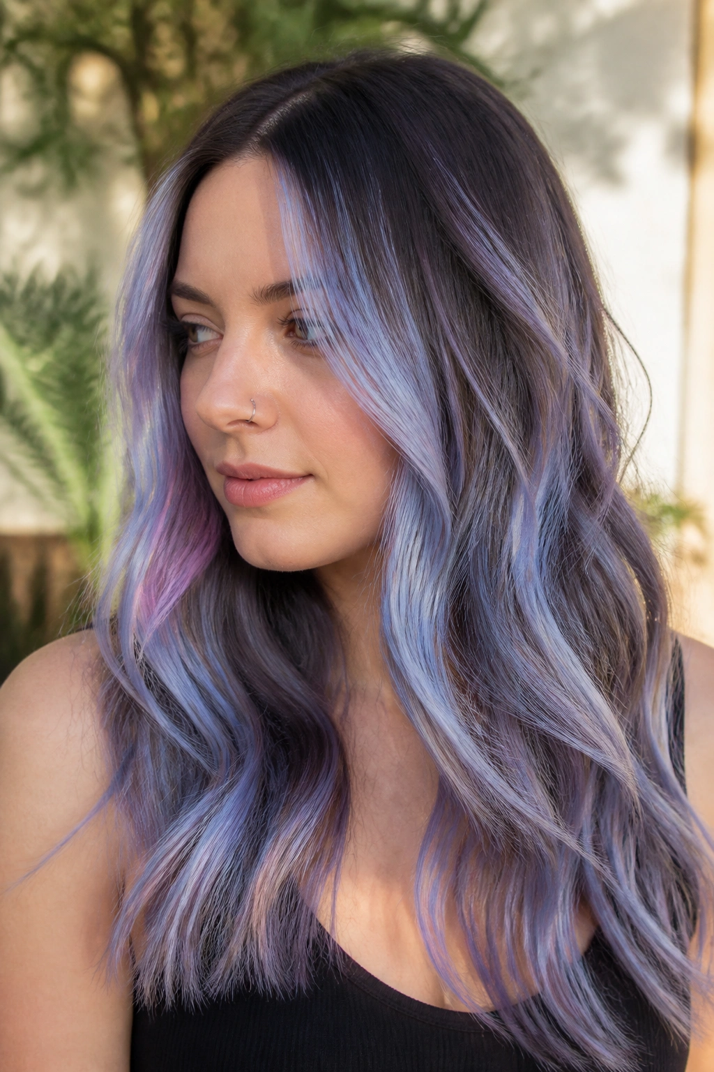 Close-up of a person with periwinkle balayage hair in an outdoor setting