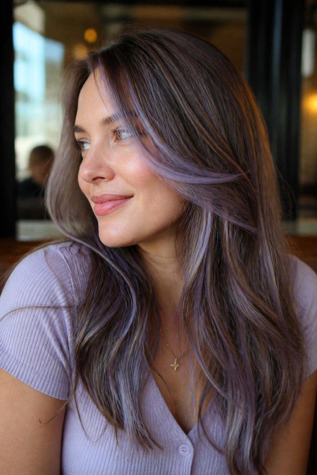 Portrait of a woman with periwinkle lilac highlights in layered hair