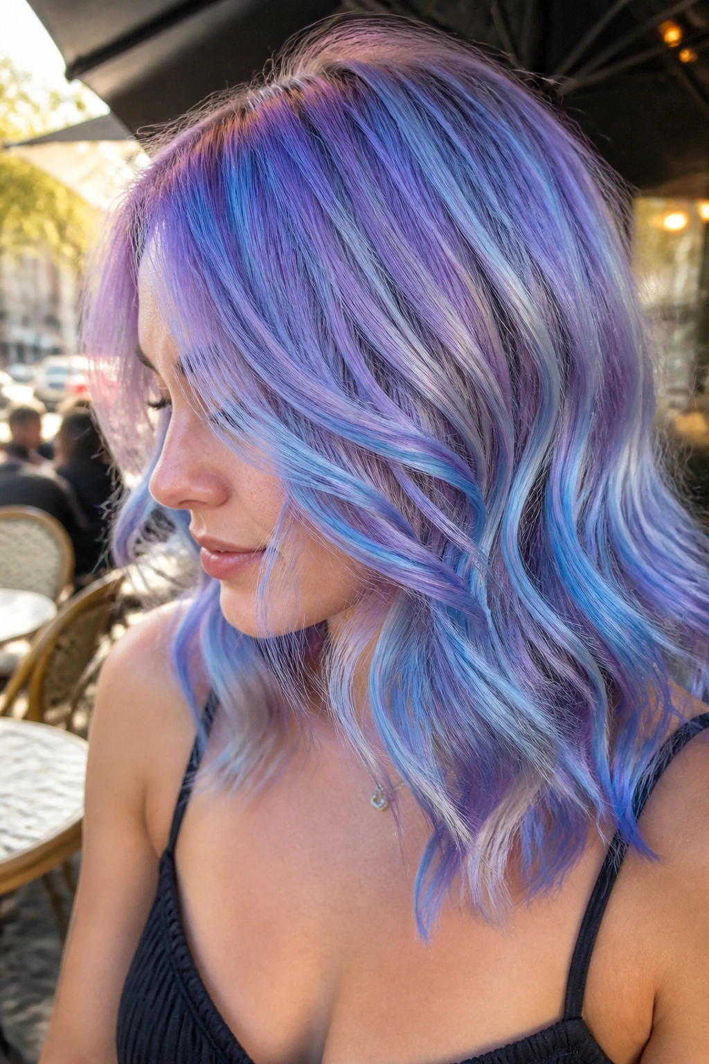Close-up of a real woman's periwinkle prism hair in waves outdoors