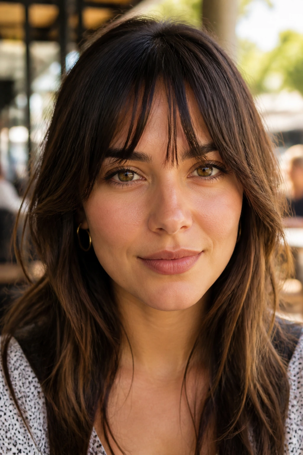 Portrait of a real woman with piecey bangs hitting the brows and splitting.