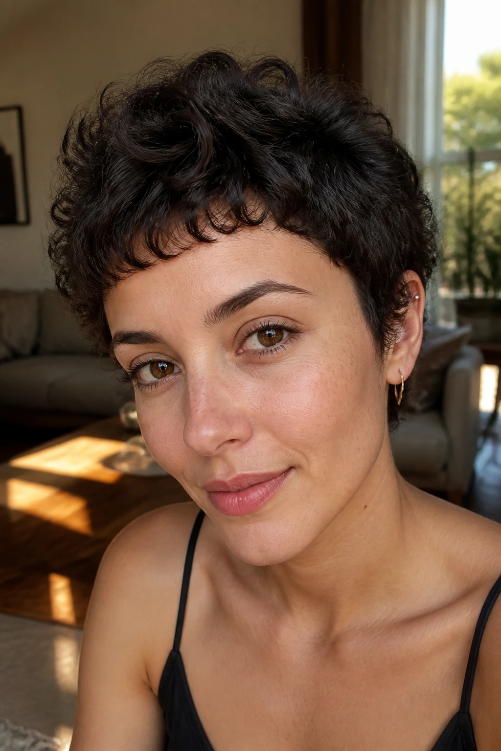 Close-up of a real woman with piecey curls and micro bangs