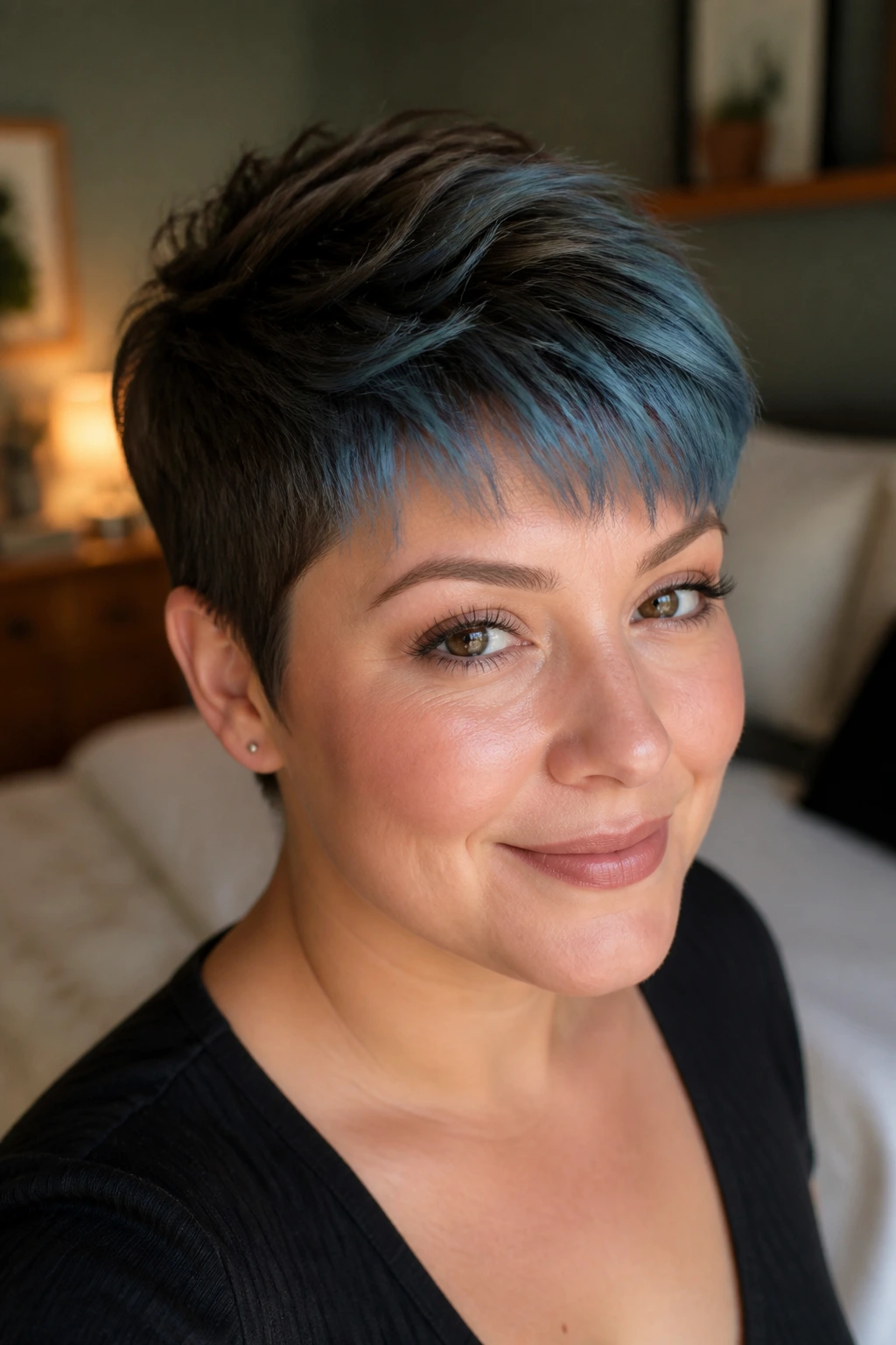Close-up portrait of a real woman with cocoa pixie and frosted blue tips in warm window light