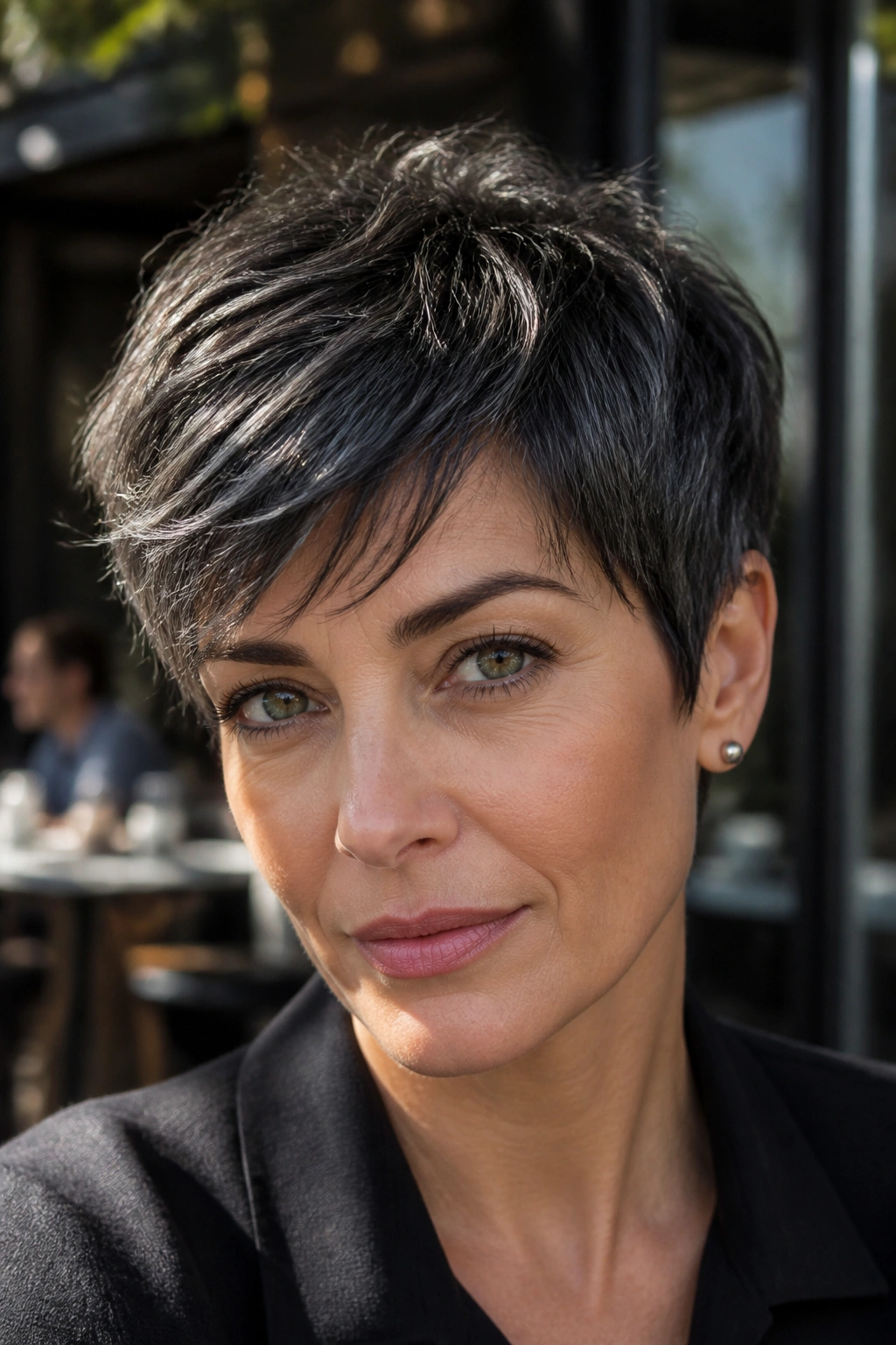 Close-up of a real woman with a pixie cut featuring black-gray highlights.