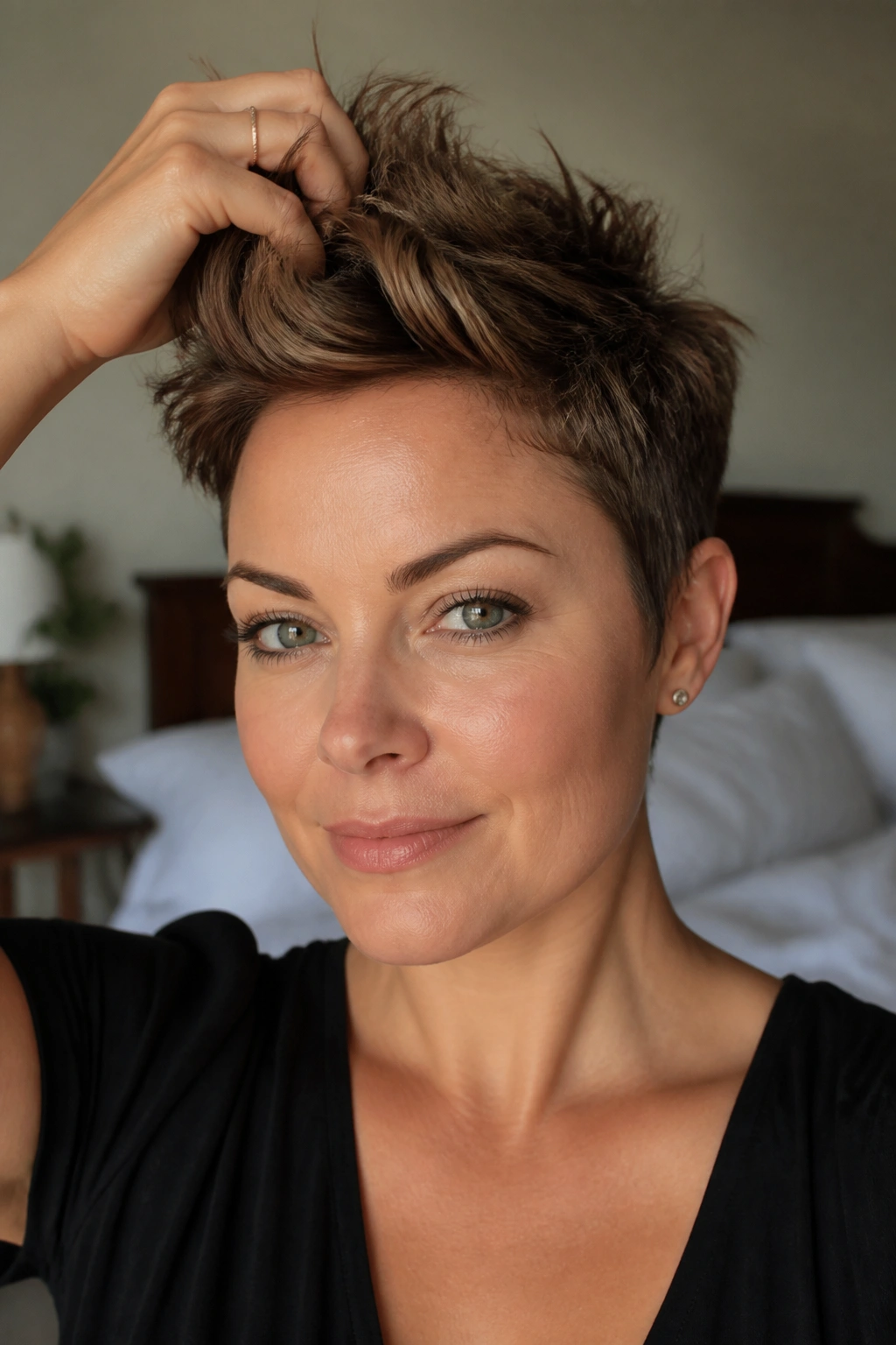 Close-up of a woman with a textured pixie and crown lift, showing vertical top height