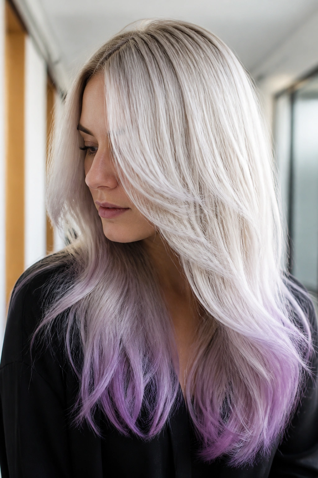 Close-up of a real woman with layered platinum blonde hair and orchid points.