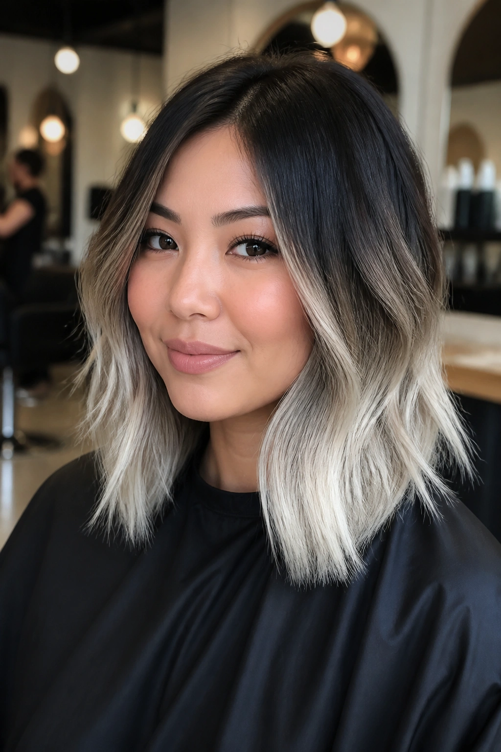 Close-up of a real person with platinum ends and a dark root melt.