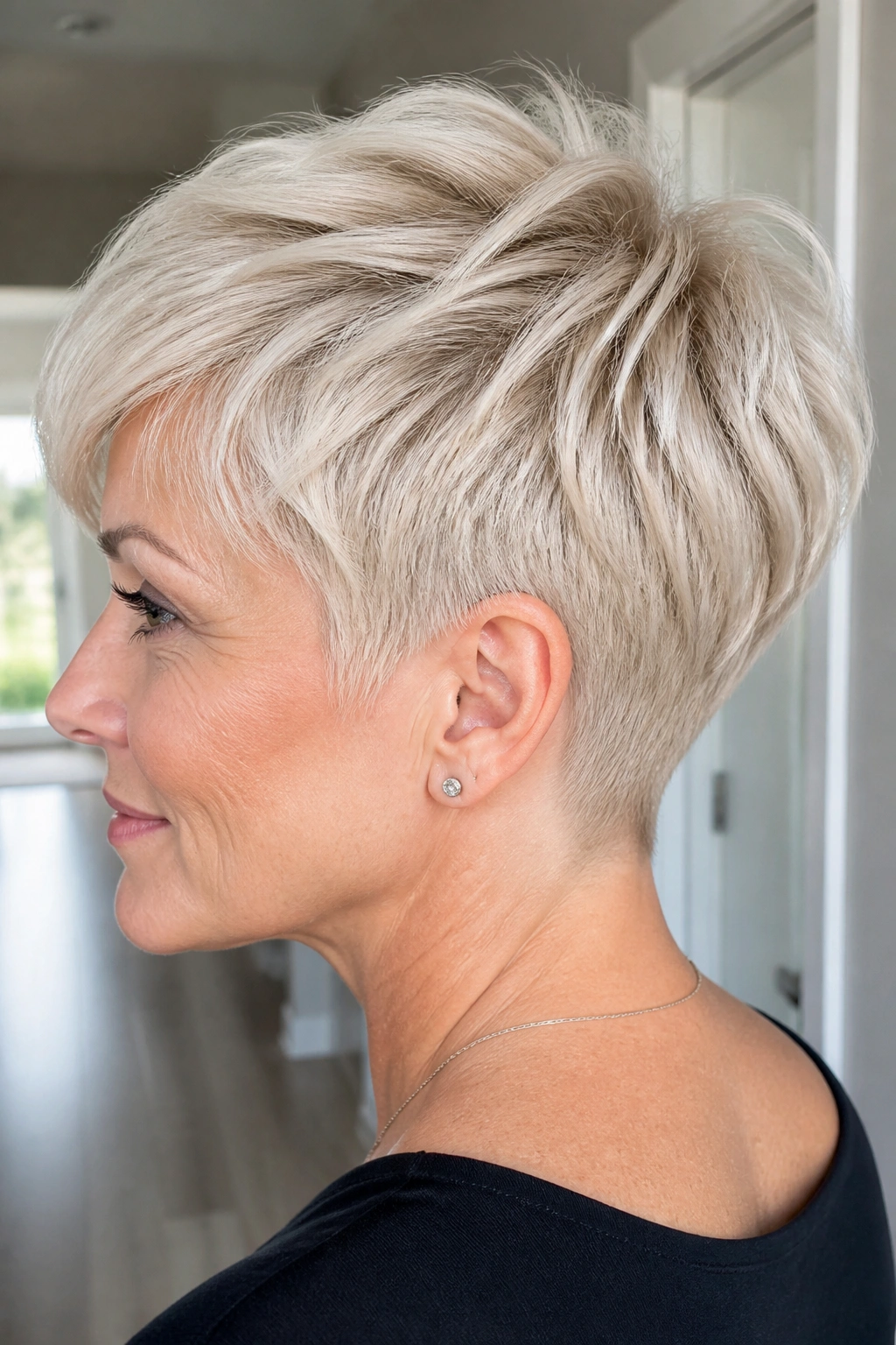 Close-up of a real woman with Platinum Tapered Pixie With a Short Nape, crisp platinum lines