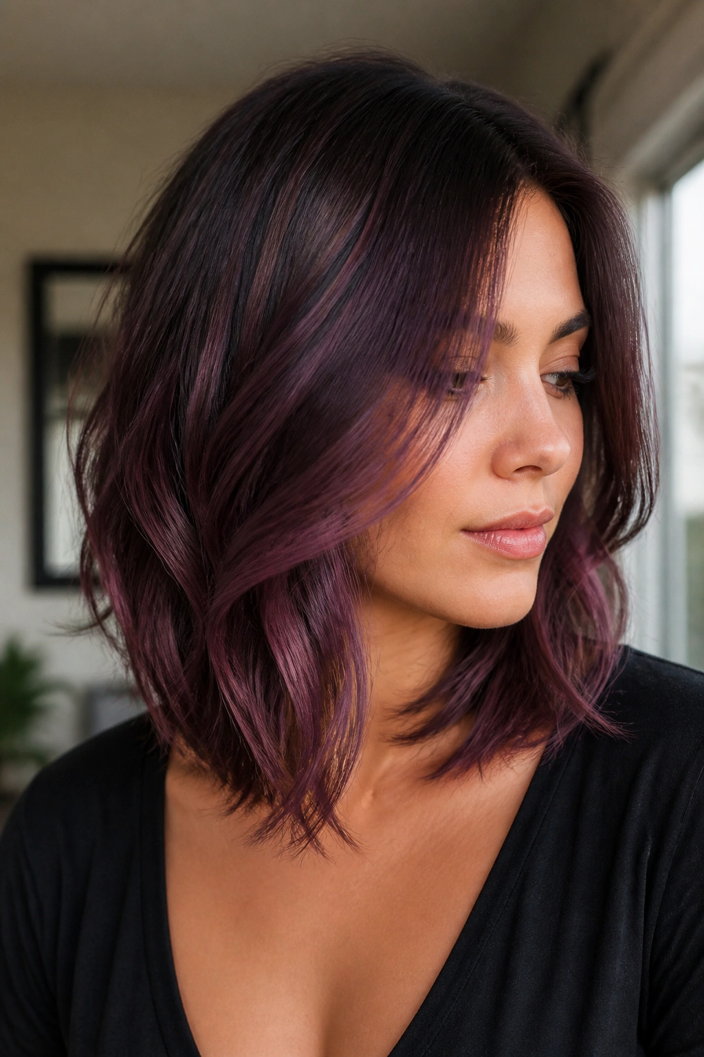 Portrait of a real woman with plum balayage on layered lob hair