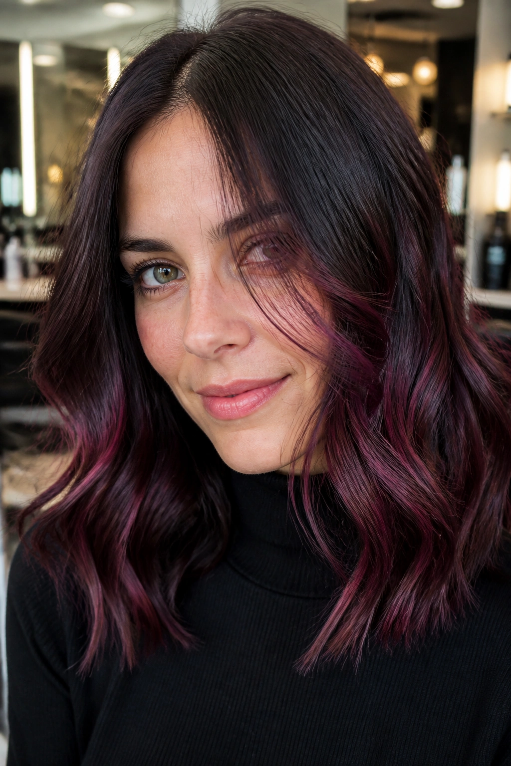 Close-up of plum brown balayage on brunette hair with plum ribbons near the face