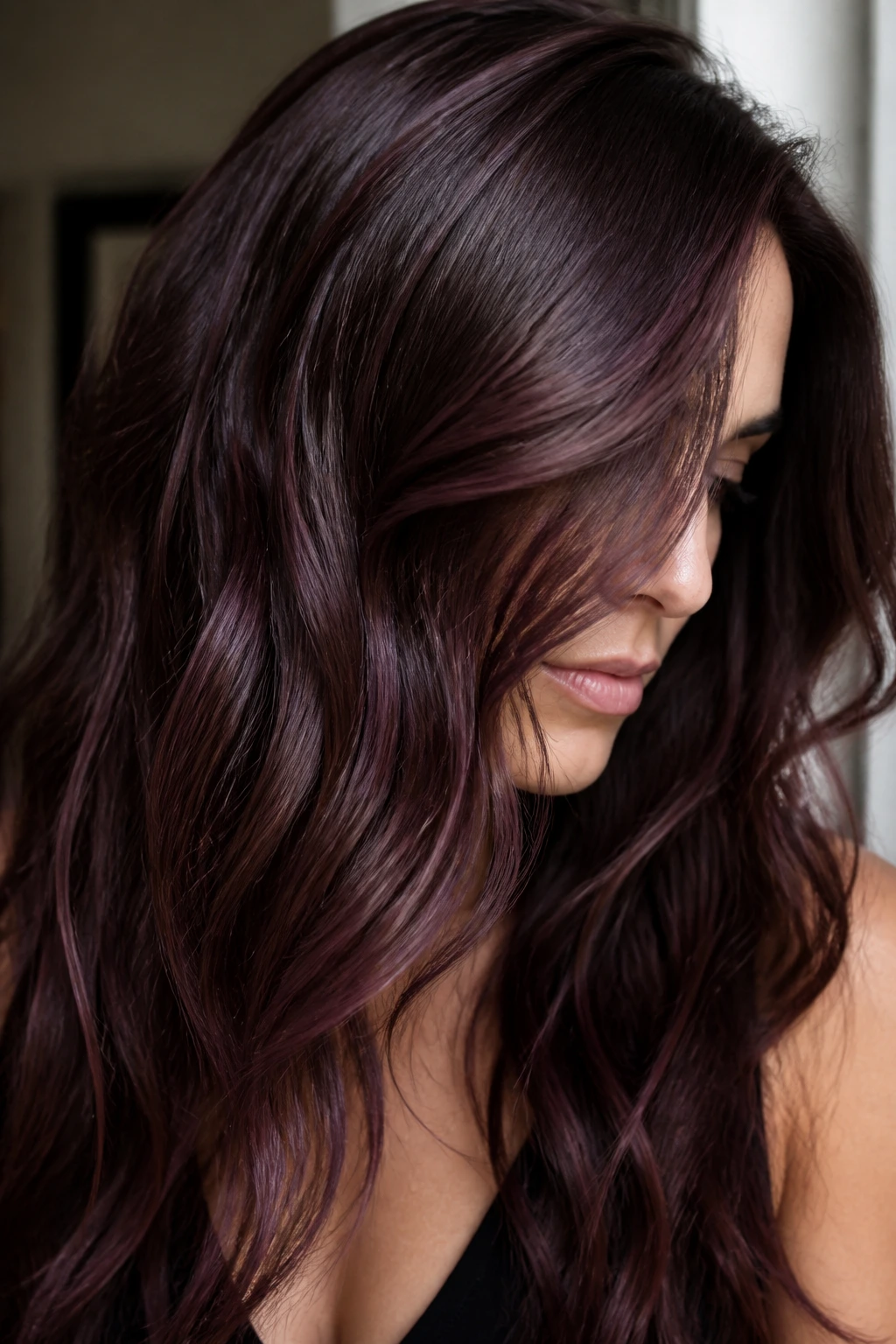 Close-up of brunette hair with plum brown threads catching light