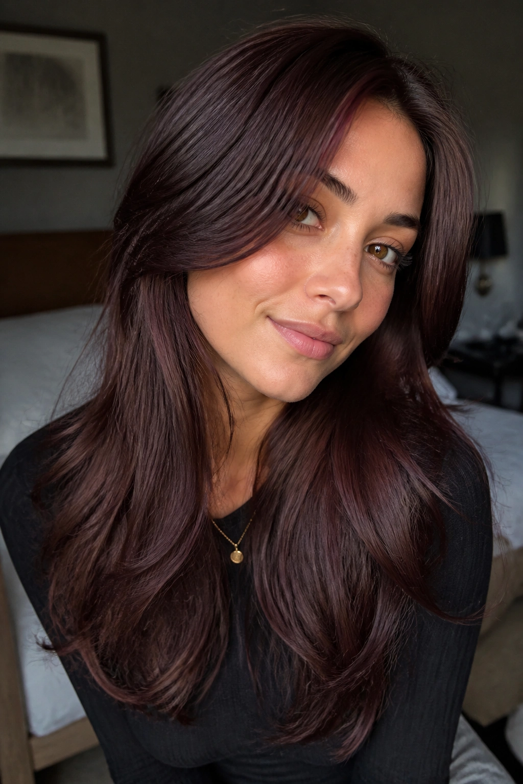 Close-up portrait of a real woman with plum-kissed chestnut brown hair in soft window light