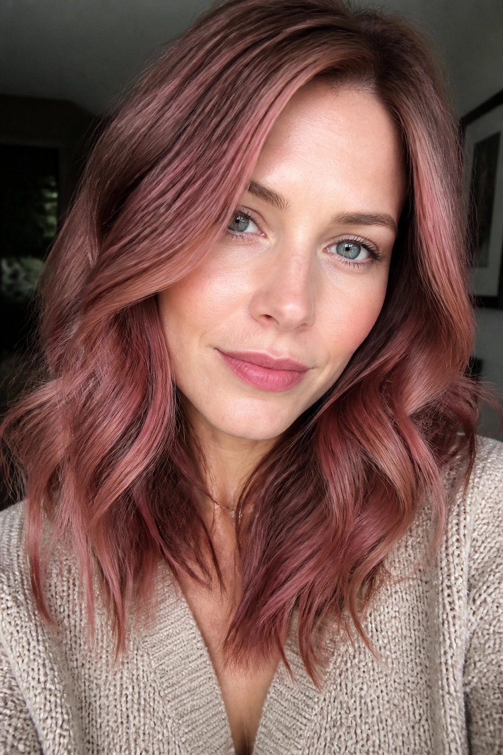 Close-up portrait of a real woman with plum strawberry blonde hair in soft window light