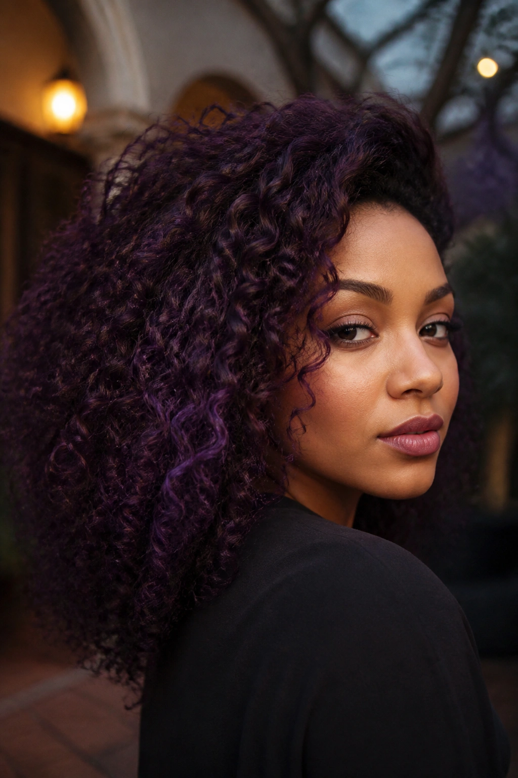 Close-up of a person with plum violet hair at dusk outdoors