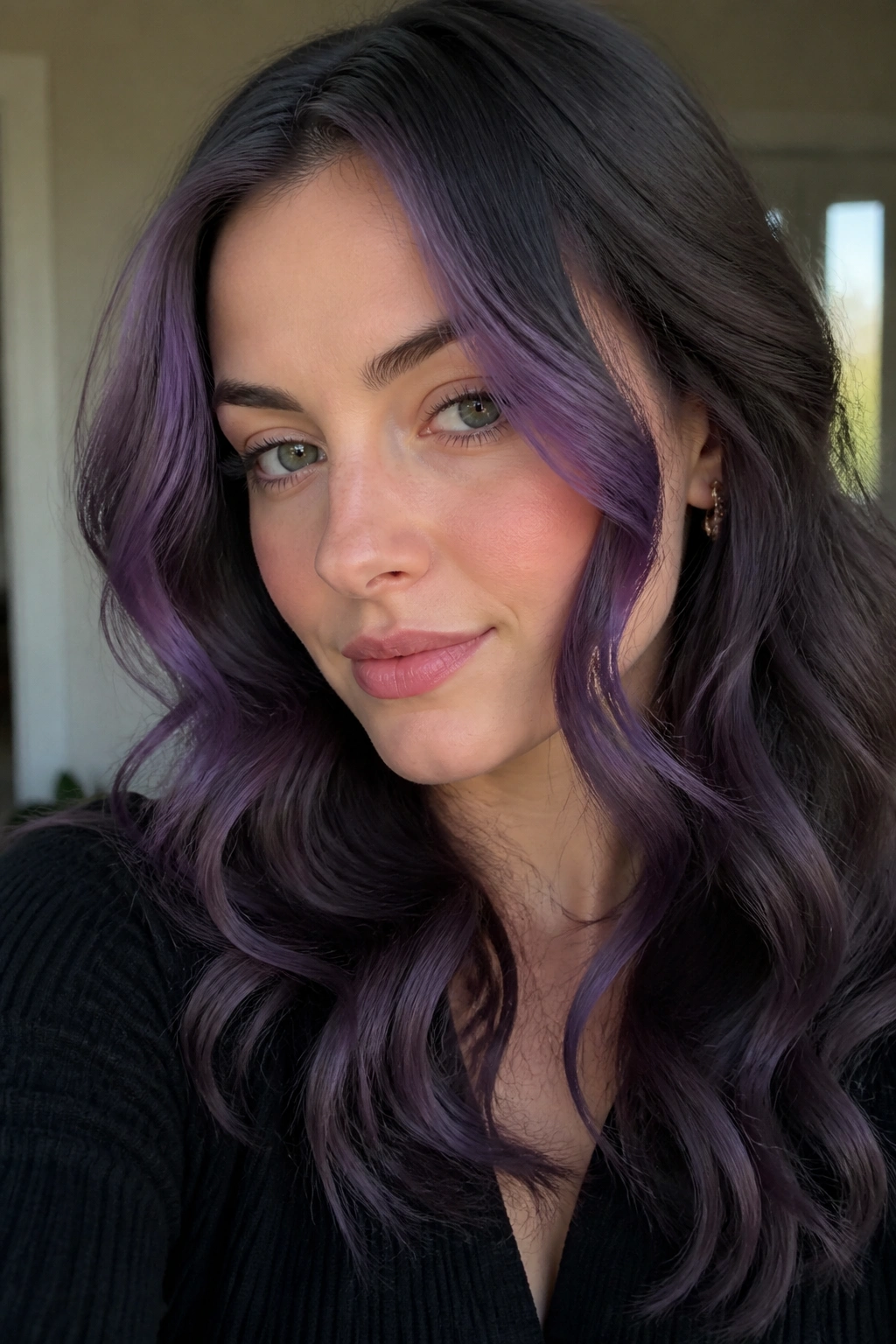 Close-up portrait of a real woman with ash-purple face-framing curls.