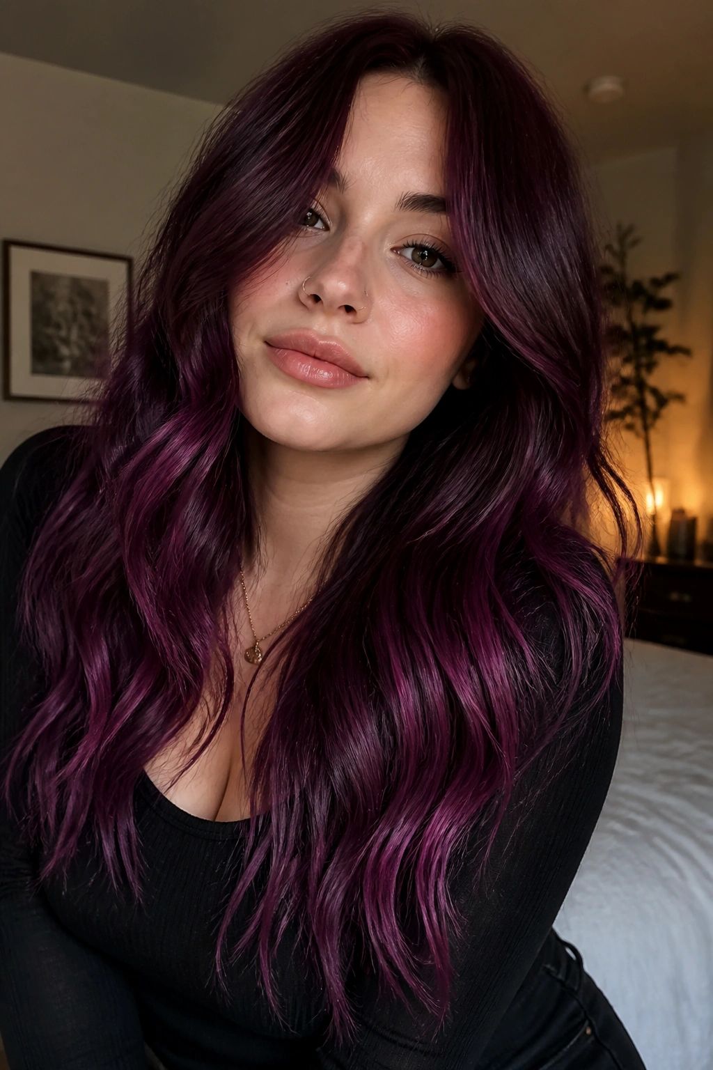 Close-up of a real woman with a black cherry to purple melt, dramatic root-to-ends gradient.