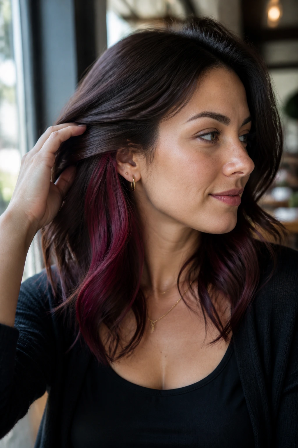 Close-up of a real woman showing raspberry burgundy peekaboo panels under the top layer.