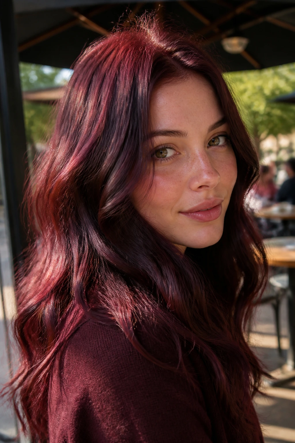 Close-up of a real woman with Raspberry Chestnut hair in daylight.