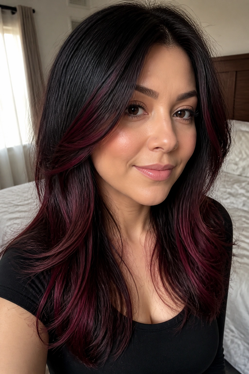Portrait of hair with raspberry lowlights on black hair.