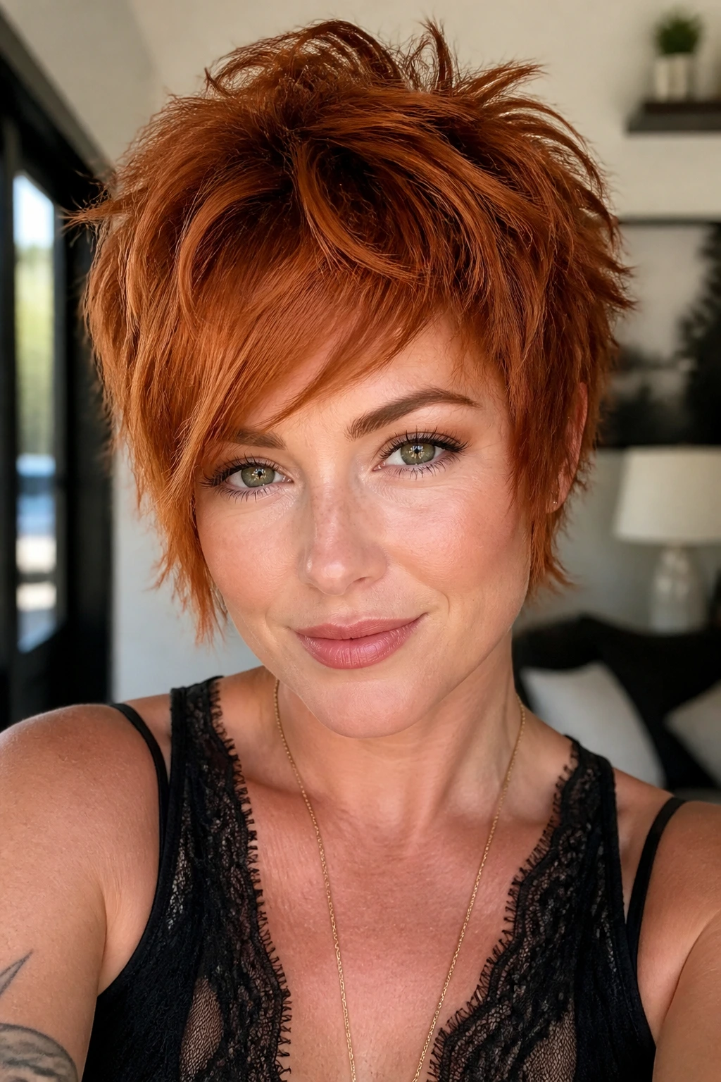Close-up of a real woman with a razor-cut shag pixie in red tones.